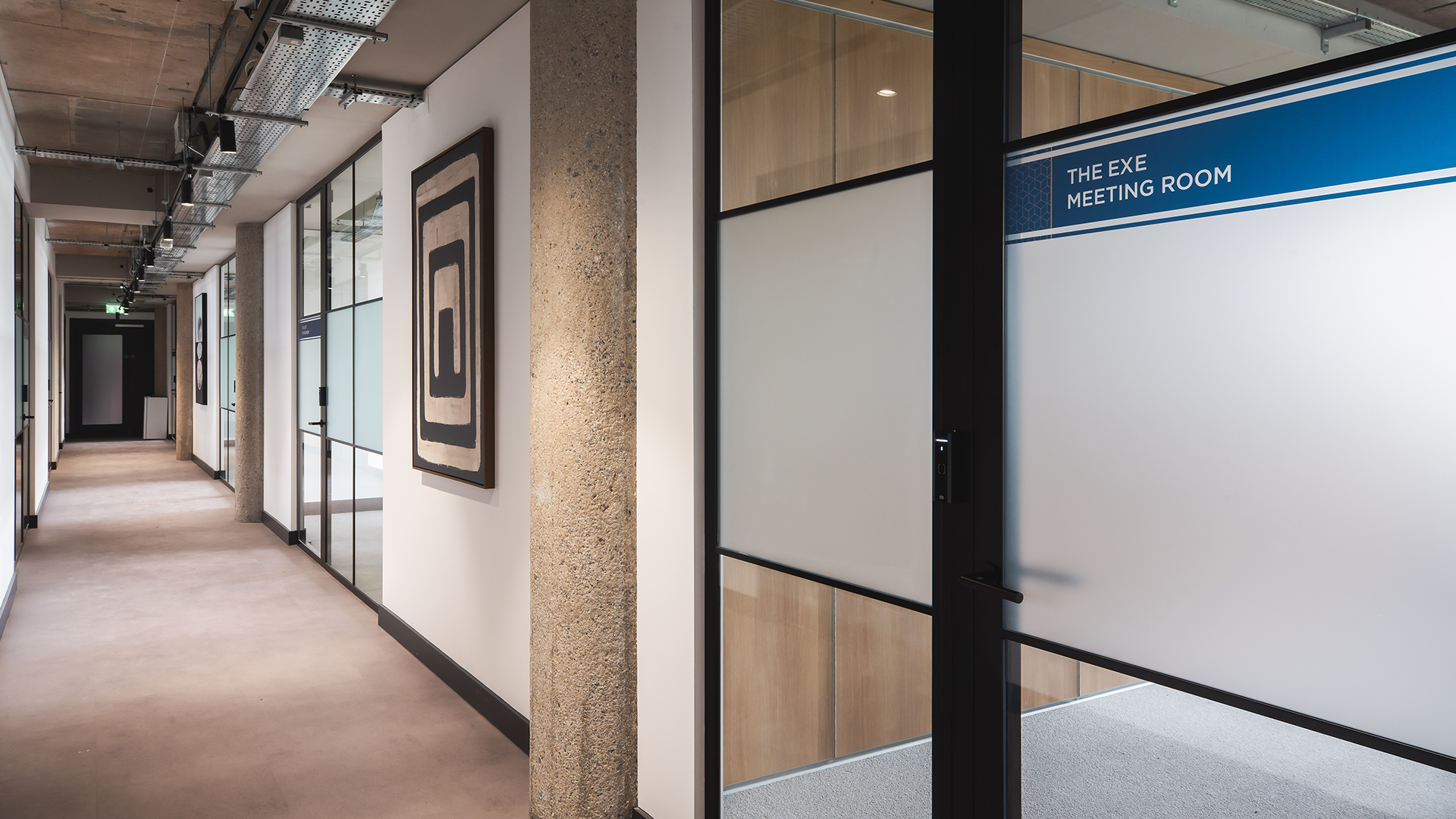 Door to the meeting rooms at winslade park with panning view of the corridor ahead