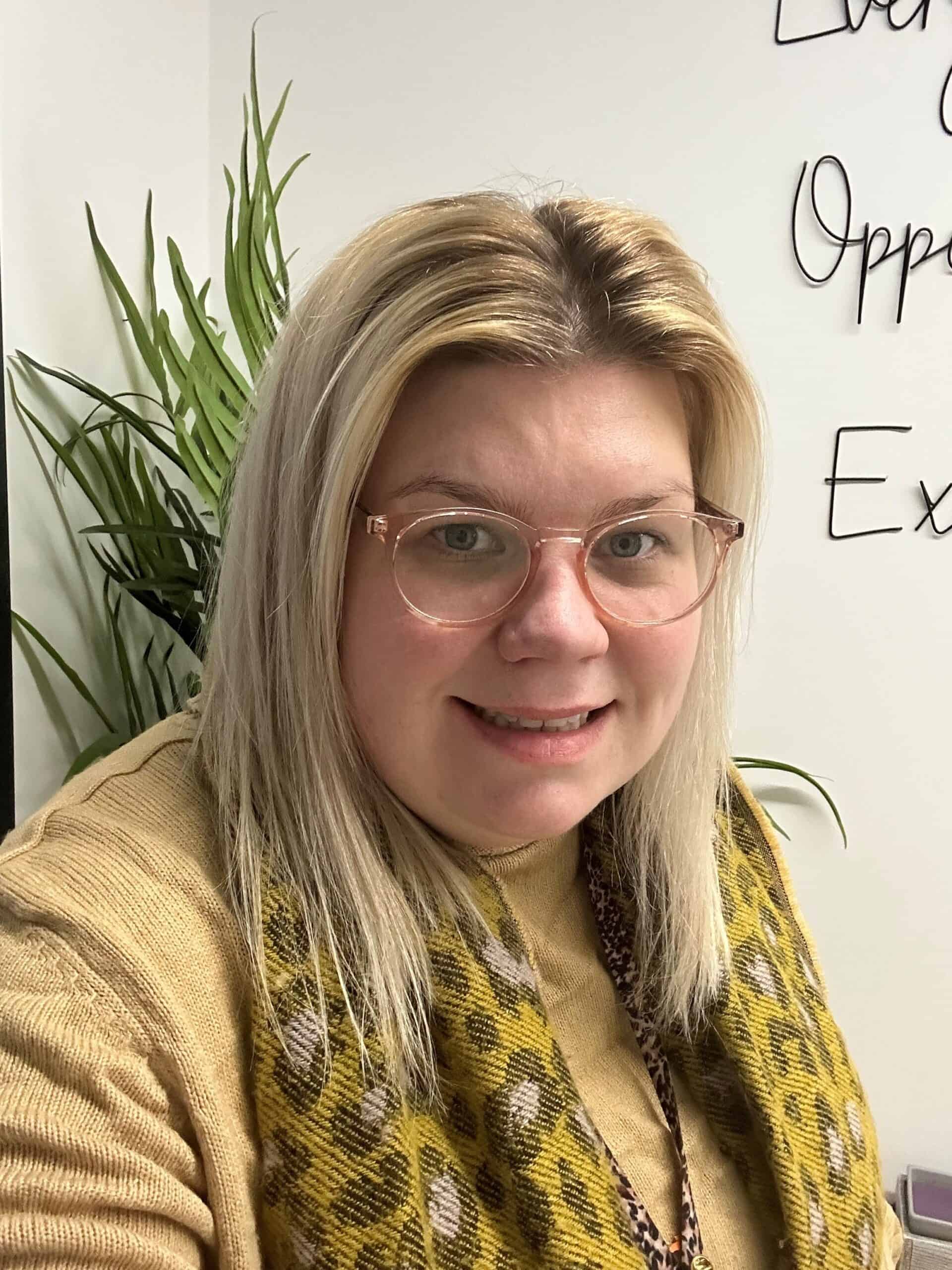 Headshot of olivia Echoes Childcare manager, wearing a yellow top and scarf